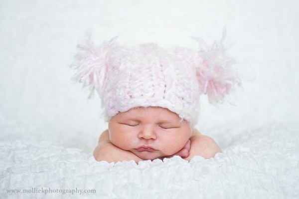 Newborn baby girl image in puffy hat via MakelyHome.com