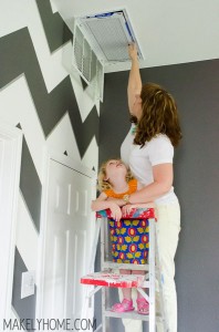 Little girl helping to replace furnace filter